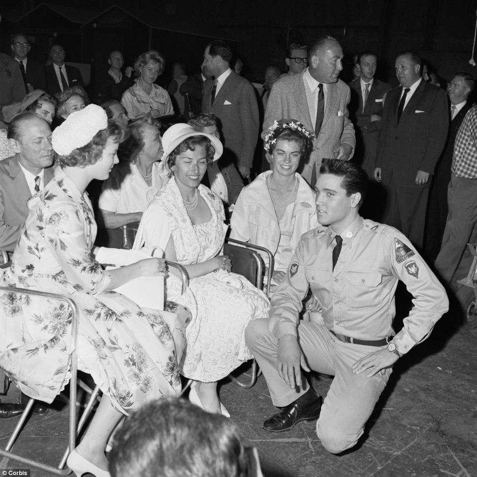 Elvis during a 1960 shoot of G.I. Blues as he meets with princesses Margrethe of Denmark (left), Astrid of Norway (center), and Margaretha of Sweden
